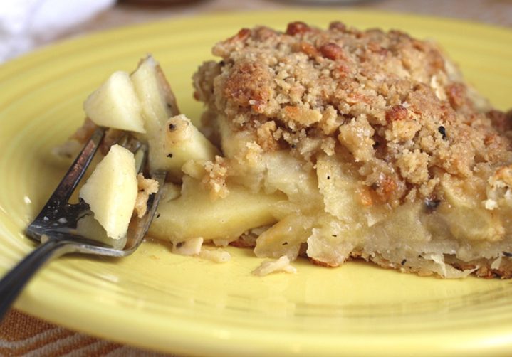 slice of apple gallete sitting on a yellow plate